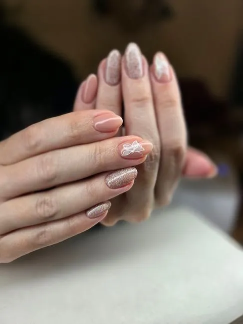 Nude gel nails with a soft shimmer accent