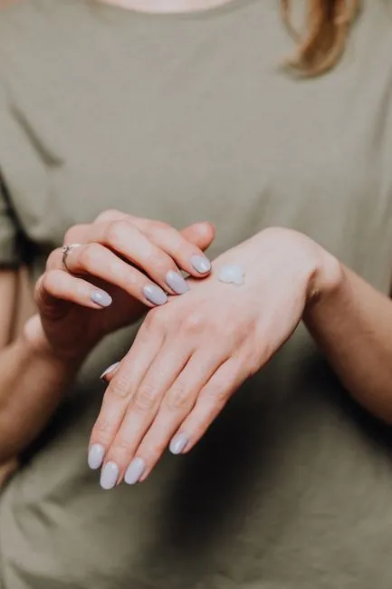 Softly finished white and nude nails on relaxed hands